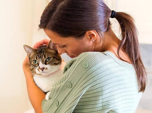Woman cuddling cat